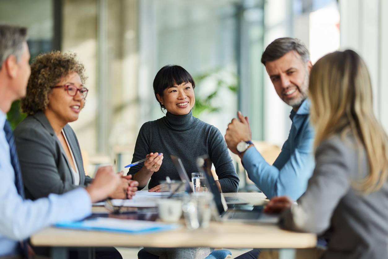 A team gathered around a table, deep in conversation